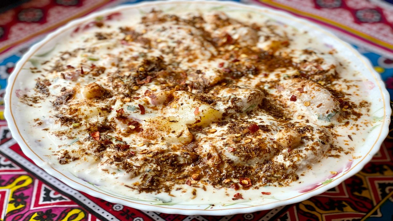 Dahi vada topped with spice mix and chutneys